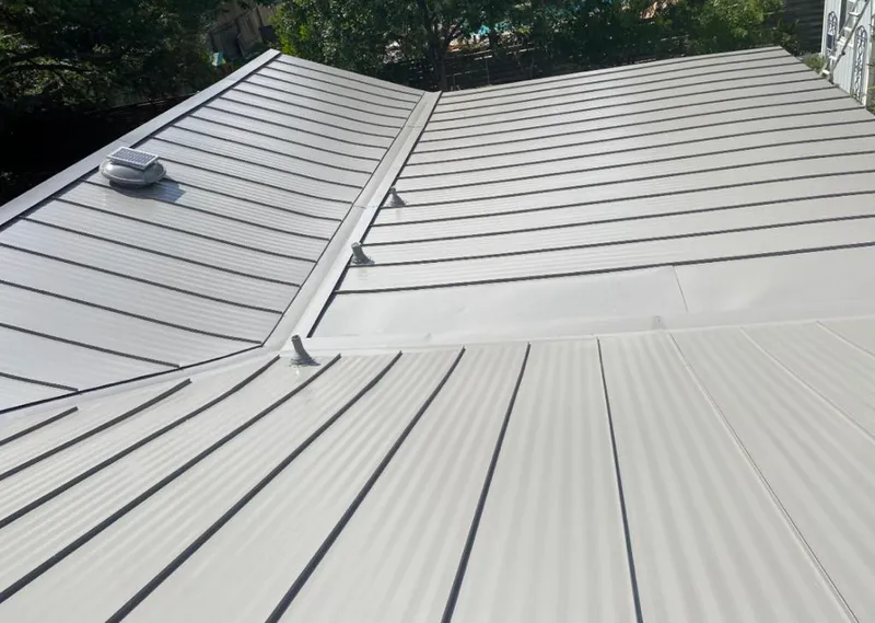 Solar attic fan installed on a metal roof for Roof Ventilation in Winona